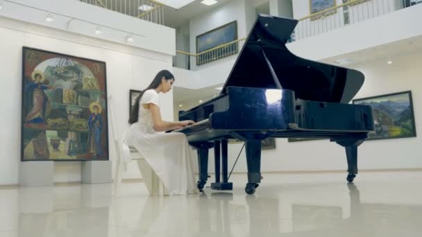 De steadicam schieten van het meisje pianospelen. 4k. — Stockvideo