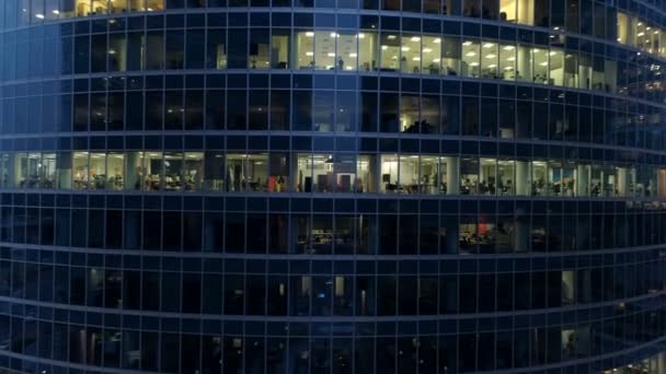 Flying among skyscrapers. Empty offices at late night. 4K. — Stock Video