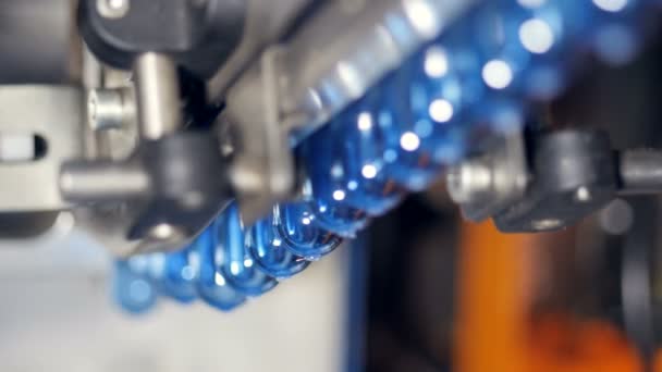 Close up view of one row of water bottle preforms. — Stock Video