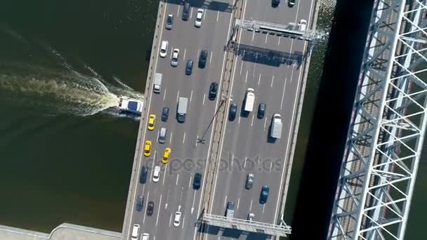 Aerial high angle of a boat moving under the bridge. — Stock Video