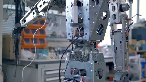 Ένα ψηλό ανθρωποειδές ρομπότ ακάλυπτα για επισκευές. — Αρχείο Βίντεο