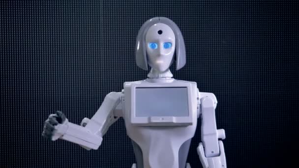 Un robot agite ses doigts noirs en saluant . — Video
