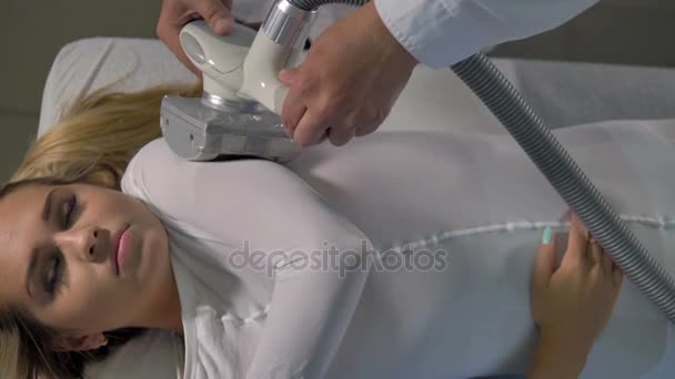 A woman with closed eyes during massage on her bent arm. — Stock Video