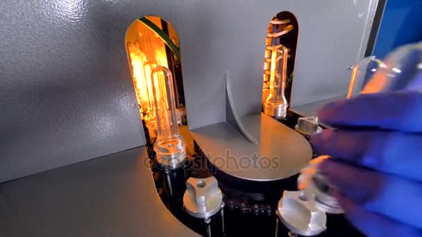 A macro view on a working PET heating line. Производство пластиковых бутылок . — стоковое видео