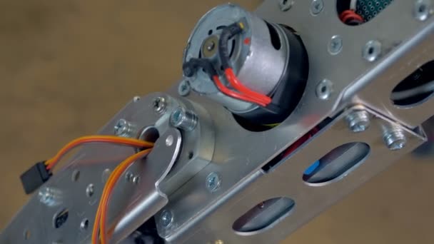 Een vergrote weergave van een humanoïde robotarm met draden, kabels en schroeven. 4k. — Stockvideo