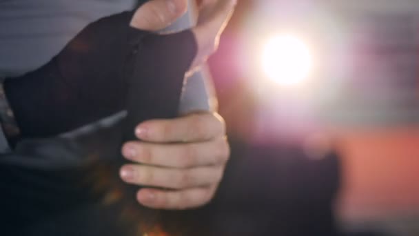 A close-up view on a boxer taping his hands. — Stock Video