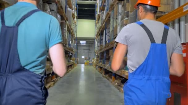 A view on warehouse workers going away. — Stock Video
