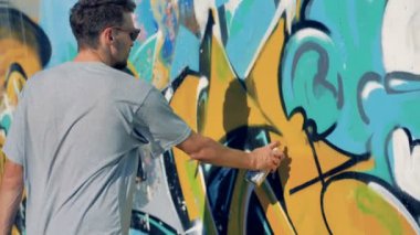 Graffiti duvar eski bir erkek sanatçı repaints.