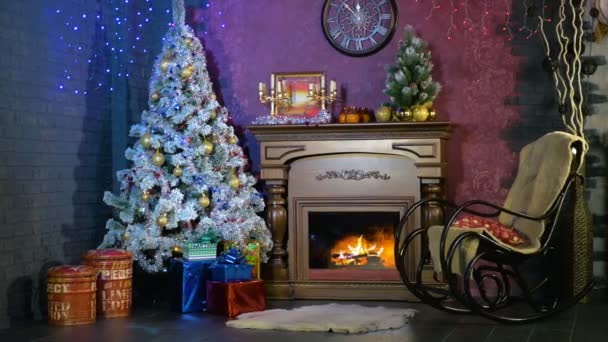 An empty rocking chair beside a Christmas fireplace. New year background. — Stock Video