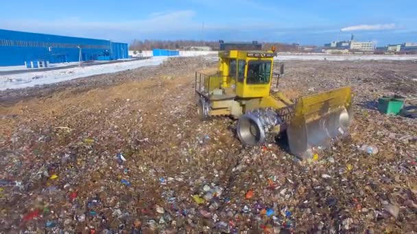 A zooming out view on a landfill compactor. — Stock Video