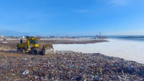 A large half-empty landfill with a working compactor. Enviromet pollution concept. — Stock Video