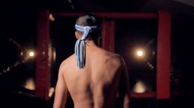 Bir Tay boks savaşçıları kafa bandı yavaş yavaş yürür.