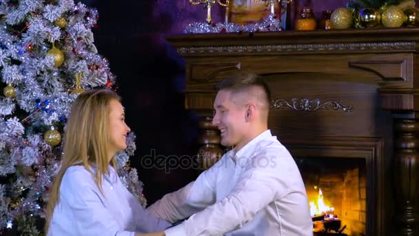 Zijn vriendin met een kerstcadeau jonge man verrassen op kerstavond. HD. — Stockvideo