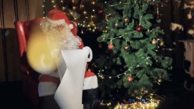 Santa okuma listesi Noel Noel ağacının yanında istiyor. 4k.