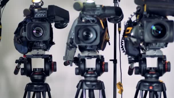 Varias cámaras de vídeo instaladas en cabezas de trípode pesadas . — Vídeo de stock