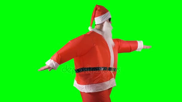 Santa Claus dělá taneční pohyby rukama a nohama na zeleném pozadí. — Stock video