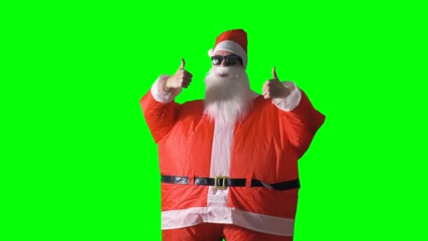 Julemanden på en grøn baggrund gør tommelfingre op og tommelfingre ned fagter . – Stock-video
