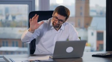 Sakallı bir işadamı iş yerinde sinirleniyor ve kağıt crumples.
