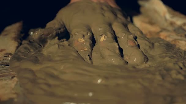 A close-up view of liquid clay leveled by hand. — Stock Video