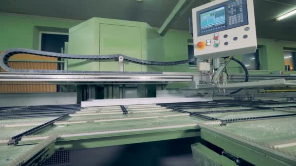 A CNC machine with a display for controlling window frame assembly. — Stock Video