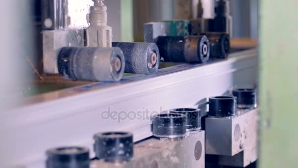 A side view on several PVC profile pieces inside a drilling machine. — Stock Video