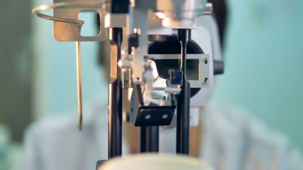 Un POV pacientes en una lámpara de hendidura oftalmológica con un médico en el fondo. 4K . — Vídeos de Stock