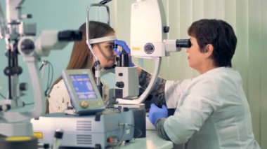 Deneyimli bir göz doktoruna kadının gözleri denetler.