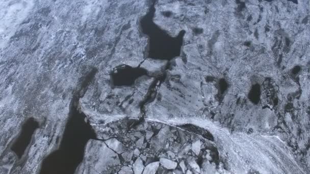 A top view from the broken ice to the undisturbed frozen river. — Stock Video