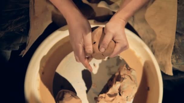 A close view on potters hands kneading clay. — Stock Video