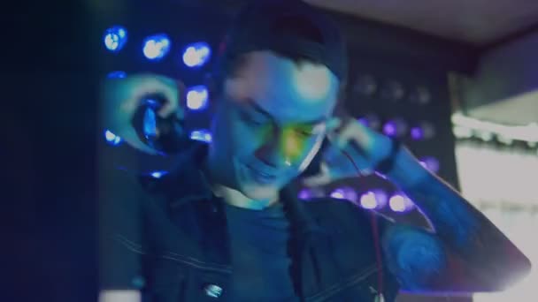 Un jeune DJ sourit au travail . 