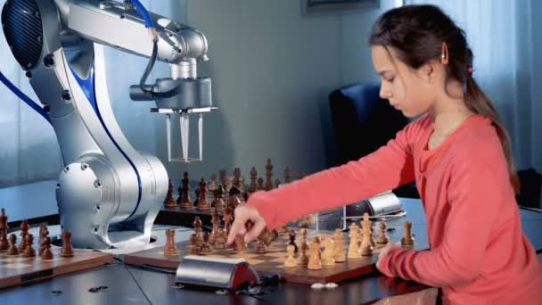 Little girl and robotic arm are capturing chess pieces of each other while playing — Stock Video