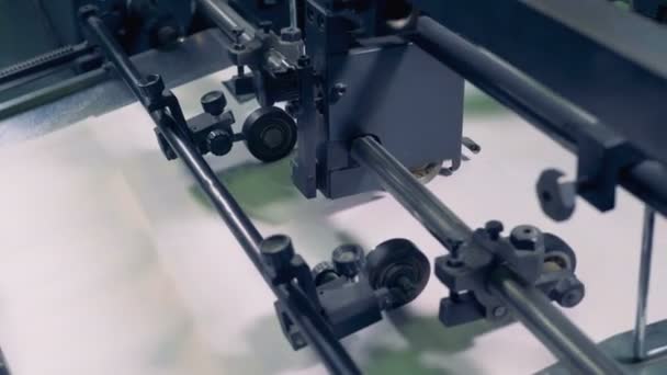 Close up of mechanical wheels and rollers pressing and stabilizing moving paper sheets — Stock Video