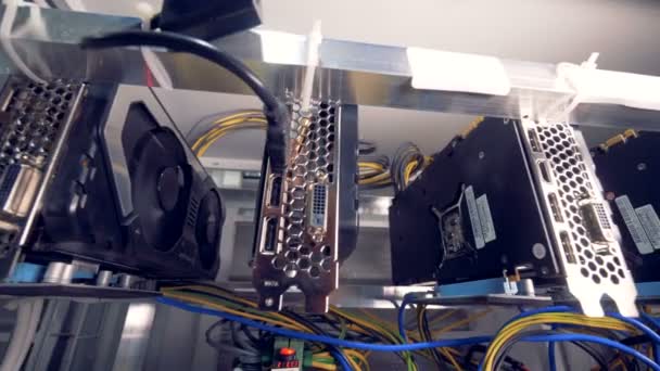 Motion footage of bitcoin mining process held by a row of graphic processing units — Stock Video