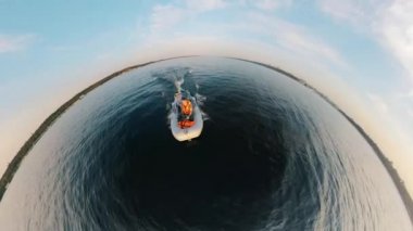 Half-circle panorama of two men sailing in a rubber boat