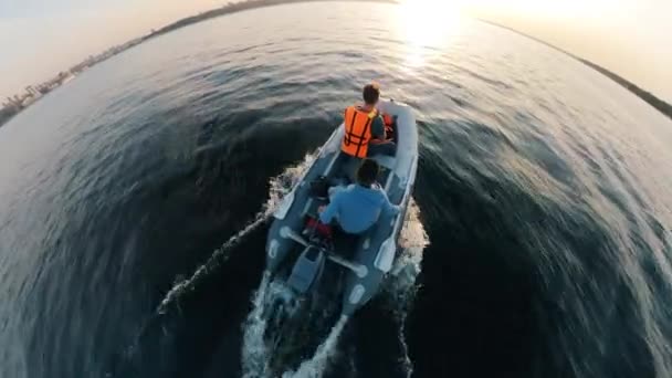 Top view of a rubber boat carrying two men — Stock Video