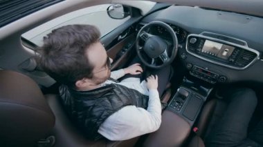 A man is being at the wheel of an automatic car