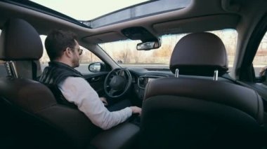 Automatically-driven car with a man sitting in it