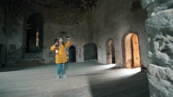 Female tourist is taking photos of an ancient room — Stock Video