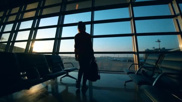 Fenêtres du salon de départ avec une femme debout près — Video