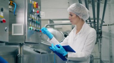 Bayan işçi fabrikada ekipman üretiyor.