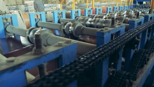 Reelers of metal-processing equipment are rotating at intervals — Stock Video