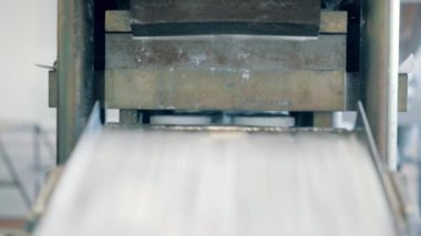 Süt ürünleri bir tesiste konveyör üzerinde hareket ediyor..
