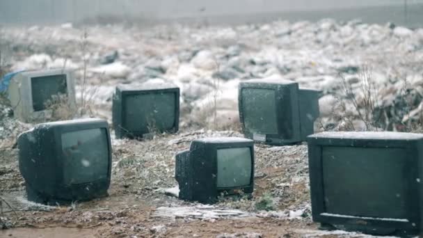 Ausrangierte Fernseher im Winter auf Mülldeponie. — Stockvideo