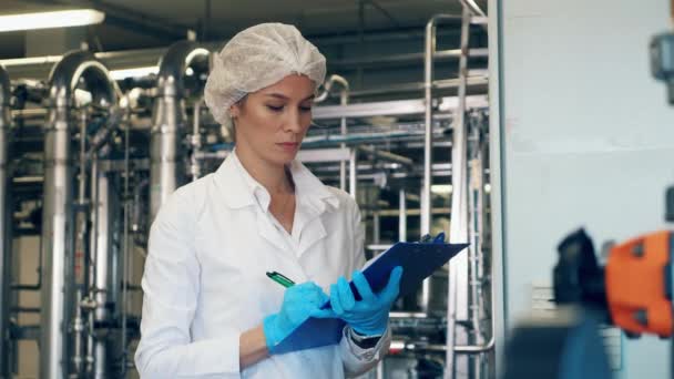 Female worker checks factory equipment, industrial machines. — 비디오