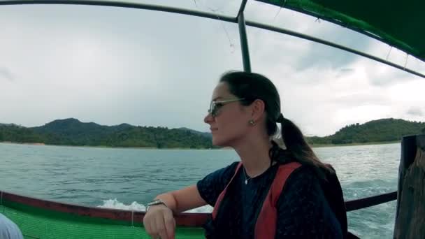 Woman sits in a motor boat, floating on water. — Stock Video