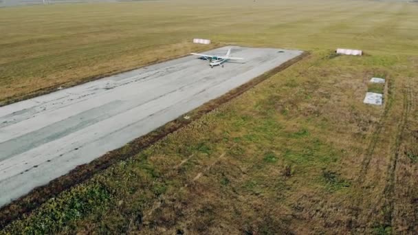 Moving airplane and an old runway in the fields — Stock Video