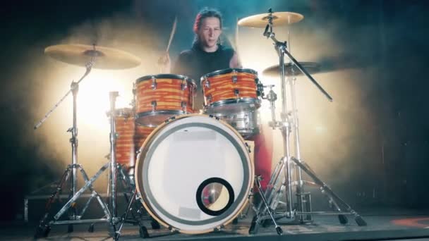 Mannelijke Drummer die drumt in rook. Vooraanzicht van een man met dreadlocks die drumt — Stockvideo