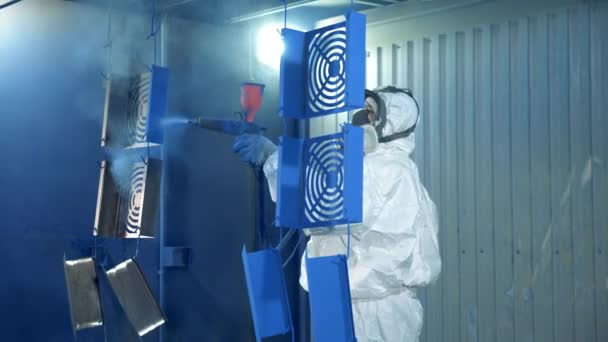 Metal parts are getting spray-painted by a specialist. Professional hand spray painting of a metal part. — Stock Video