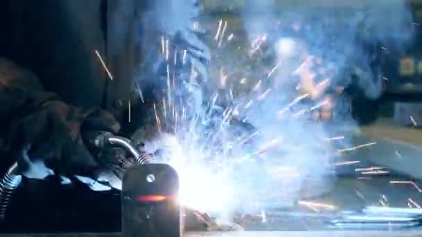 Kovový paprsek se svařuje a odnáší pryč. Profesionální svářečka pracující v průmyslové kovodělné továrně. — Stock video