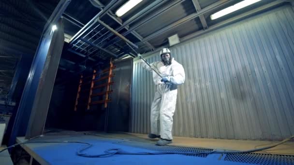 Pieza de metal se está poniendo en marcha desde el horno de pintura por el trabajador en uniforme de protección — Vídeo de stock